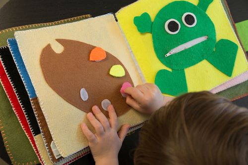 Child's hand and sensory style book