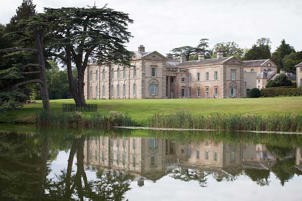 View across a lake to Compton verney house