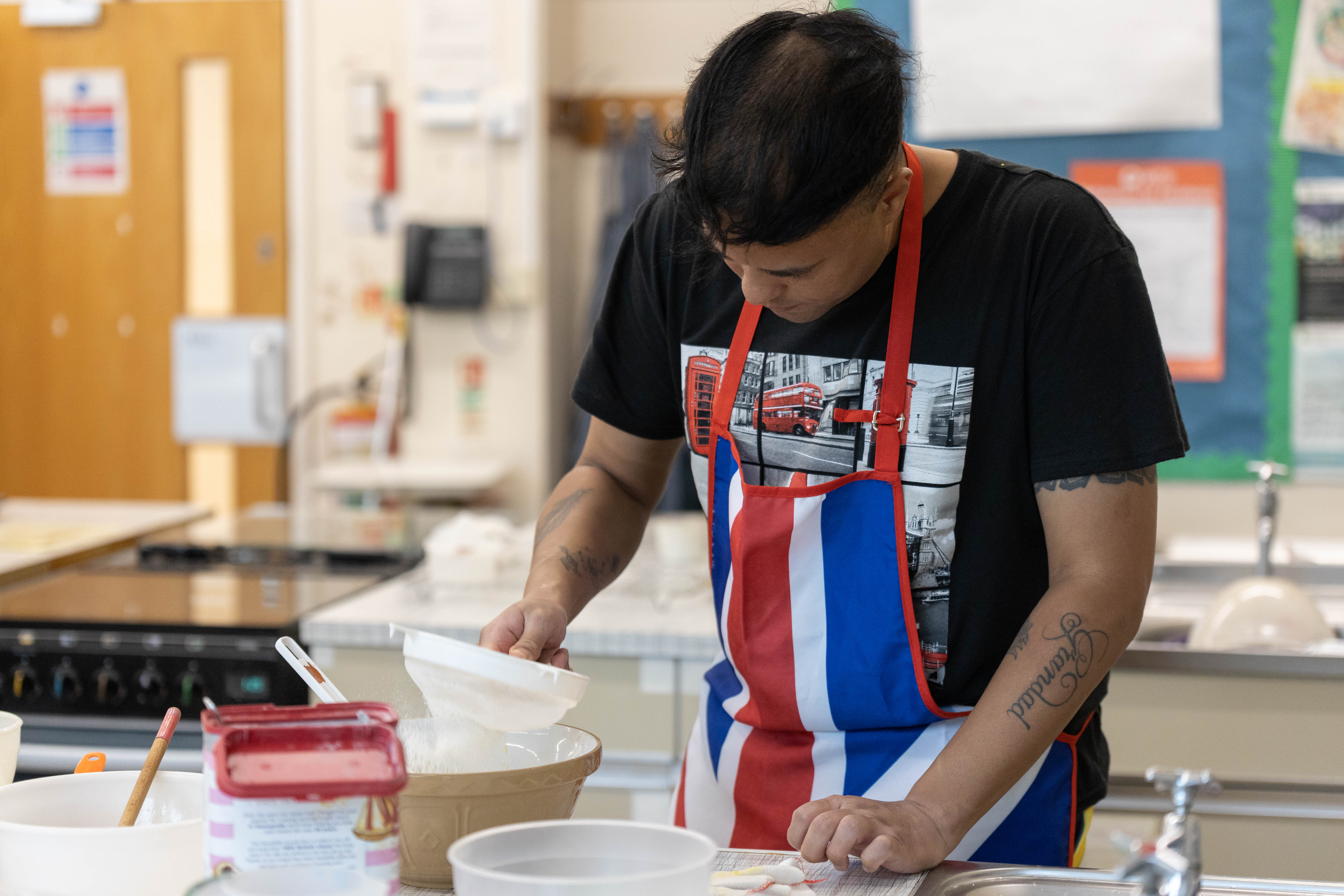 An ACL learner sifting flour into a bowl
