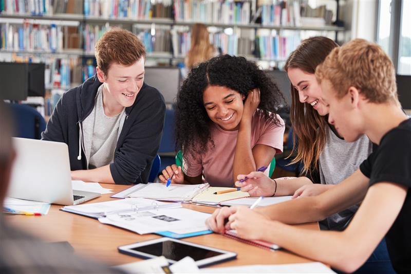 Teens reading a book
