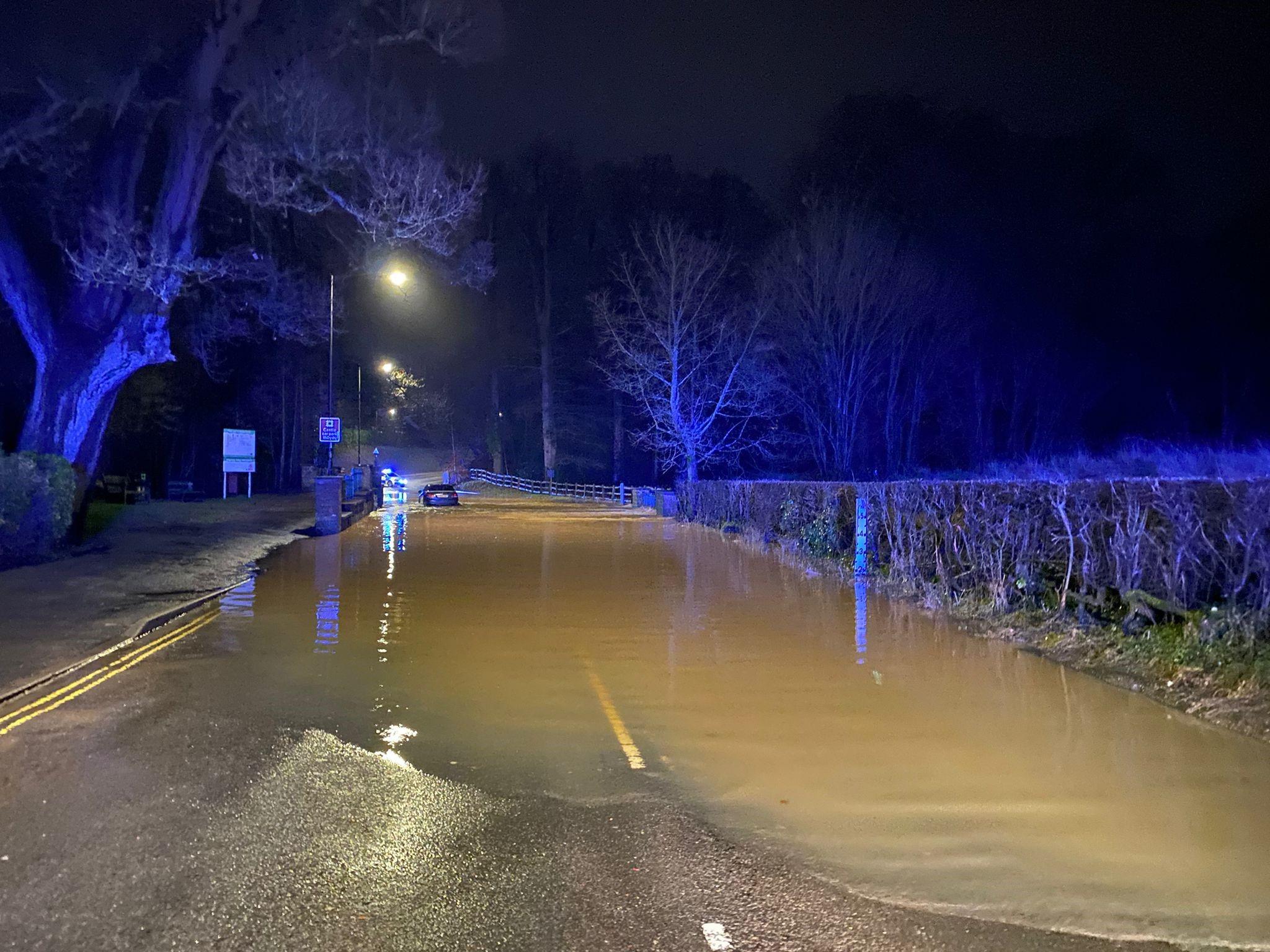 Image of a flooded road at night.