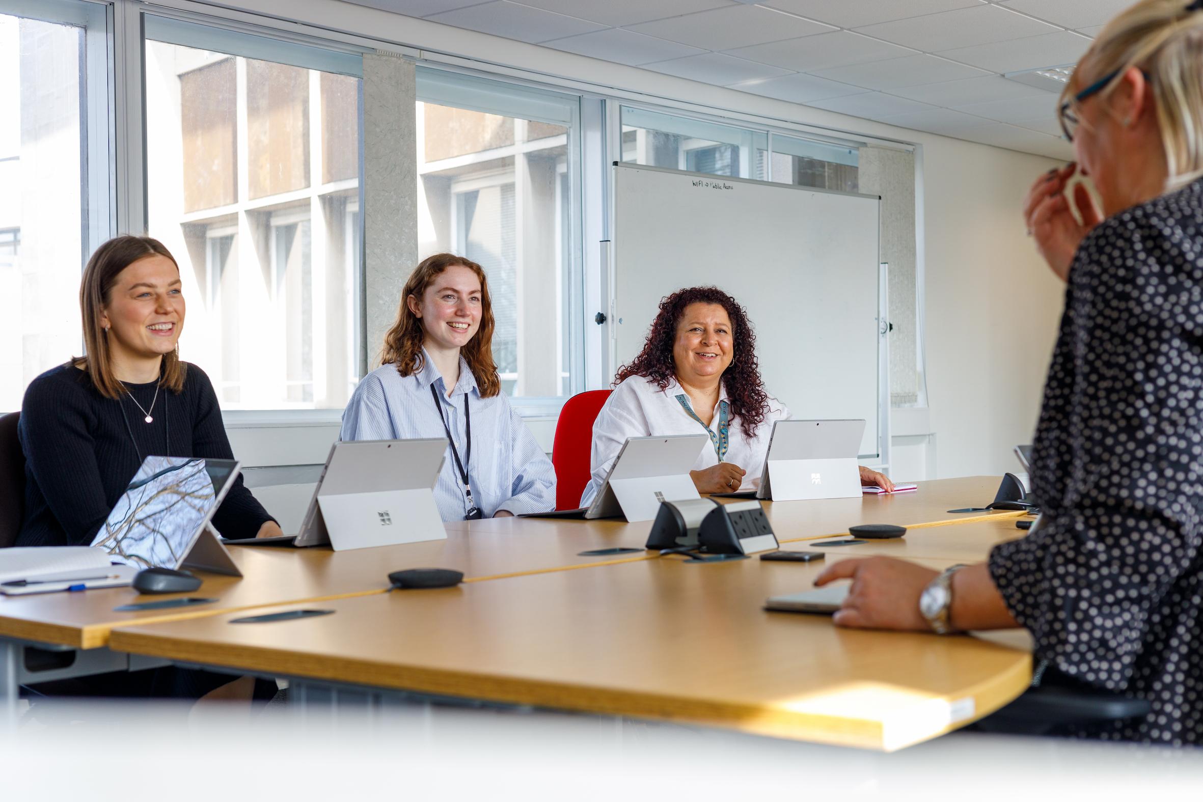 An image of someone having an interview at a meeting table