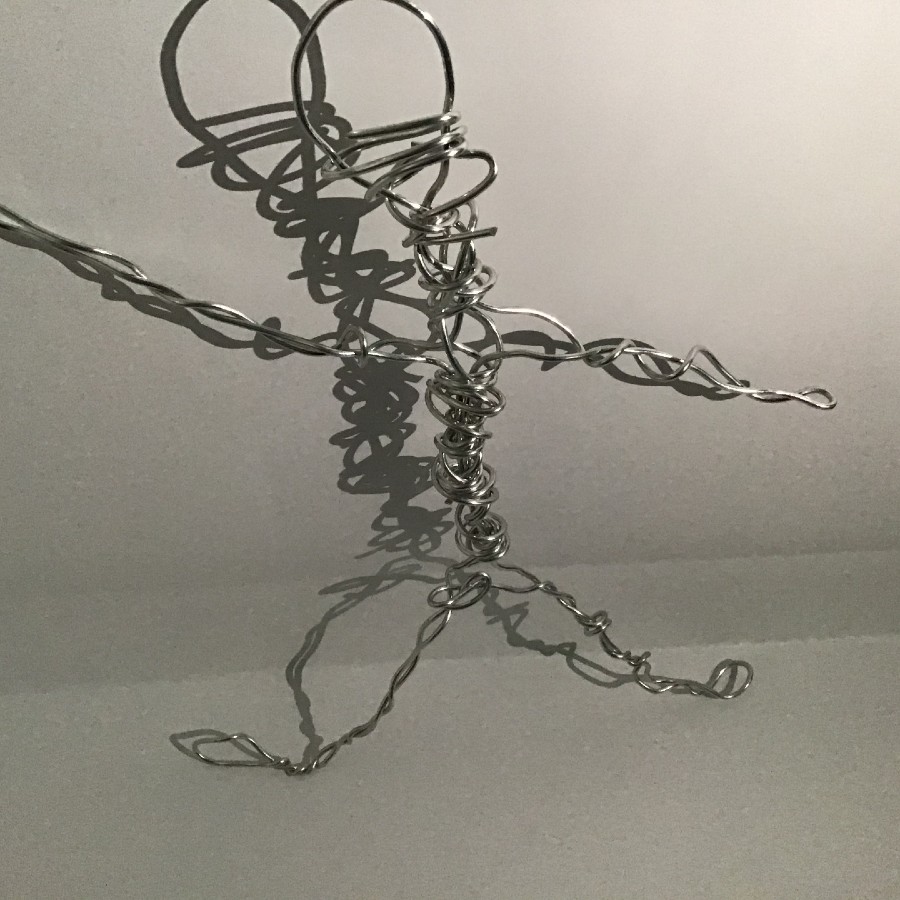 A photo of a wire statue of a person.
