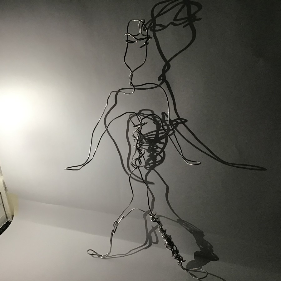 A photo of a wire statue of a person.