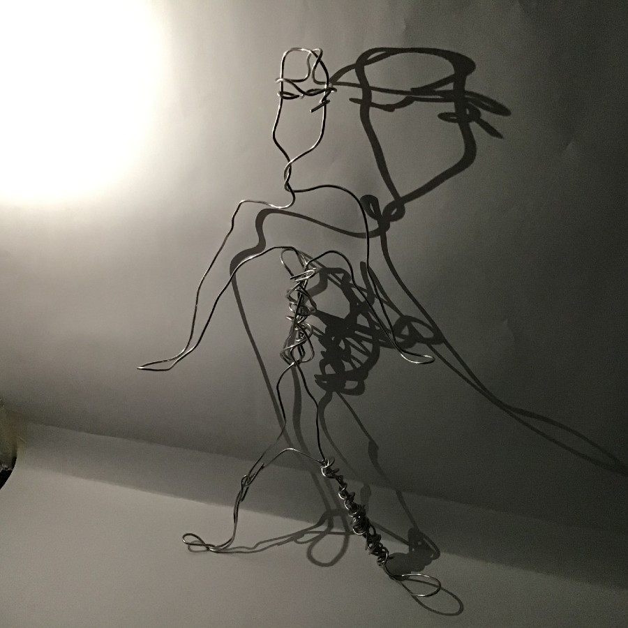 A photo of a wire statue of a person.