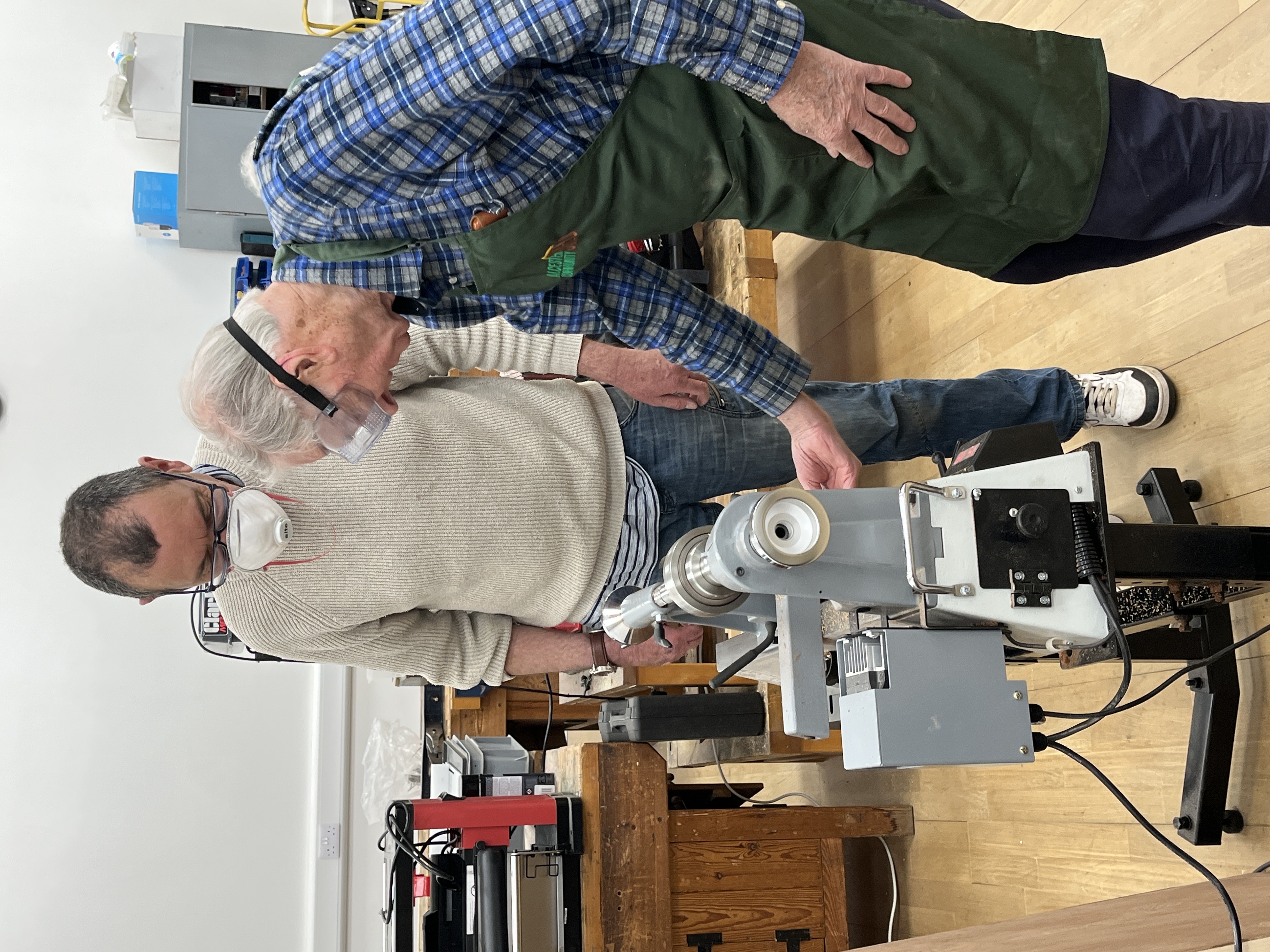 Volunteer and a service user using some equipment