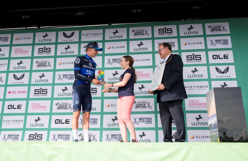Trophy design competition winner Amy Belcher and WCC Chairman Edward Harris present trophy to stage winner Romain Grégoire