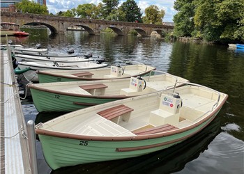 Boats lined up along the bank of the River Avon