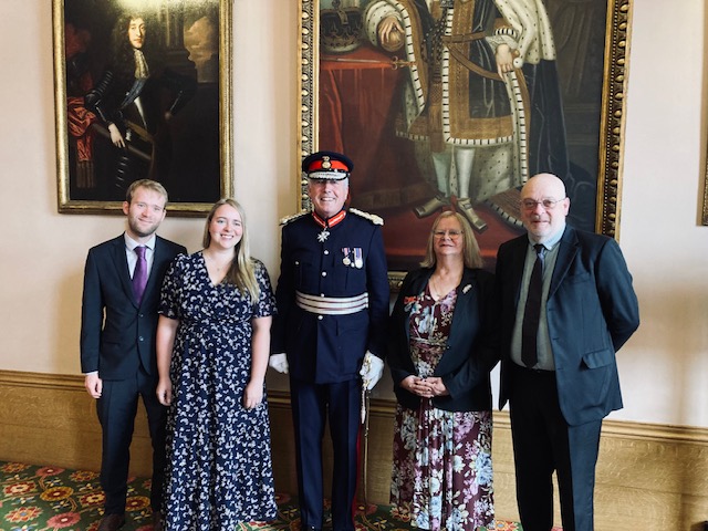 Caroline Chadwick (second from right) being presented with her British Empire Medal by Lord Lieutenant Tim Cox, alongside her family.