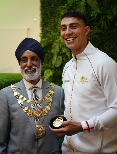 Mayor of Warwick, Parminder Singh Birdi, with Lewis Williams holding his gold medal, smiling at the cameras