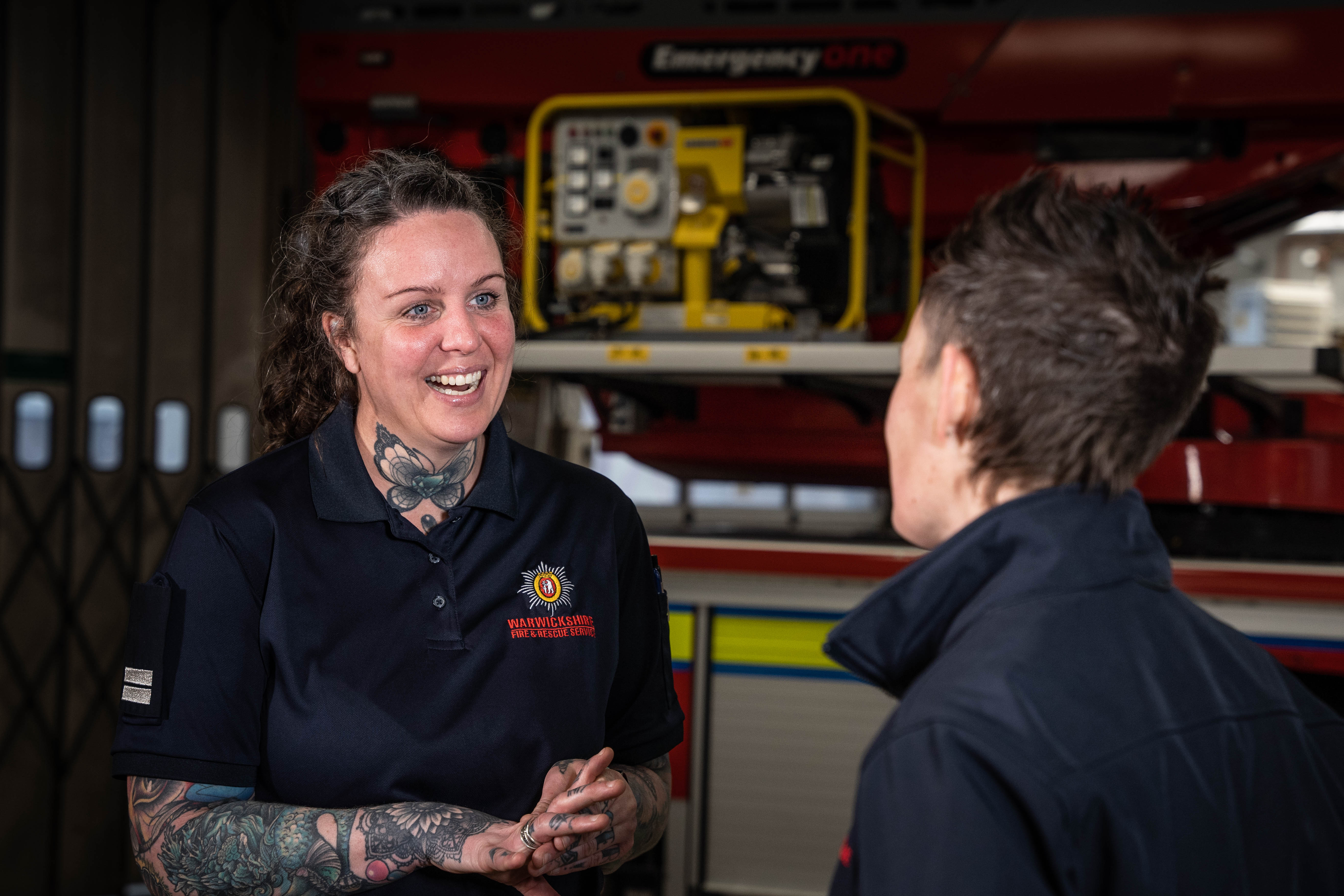 Dawn Roodhouse, Crew Manager at Warwickshire Fire & Rescue Service pictured speaking with another firefighter in front of a fire engine