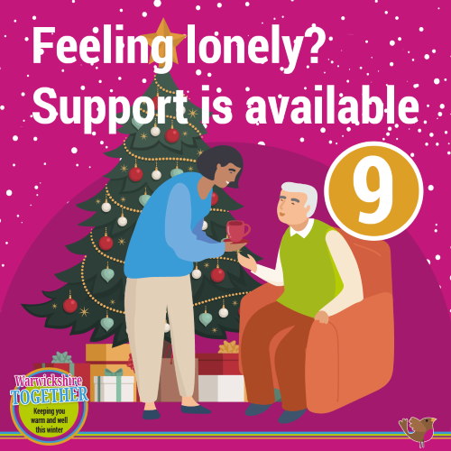 Two people talking by Christmas tree