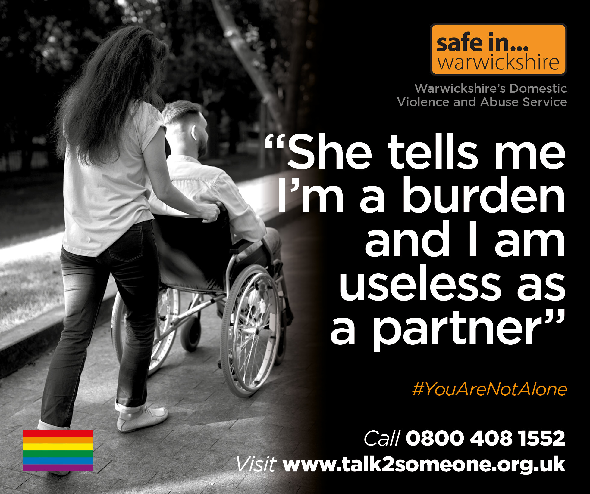 A woman pushes a man in a wheelchair