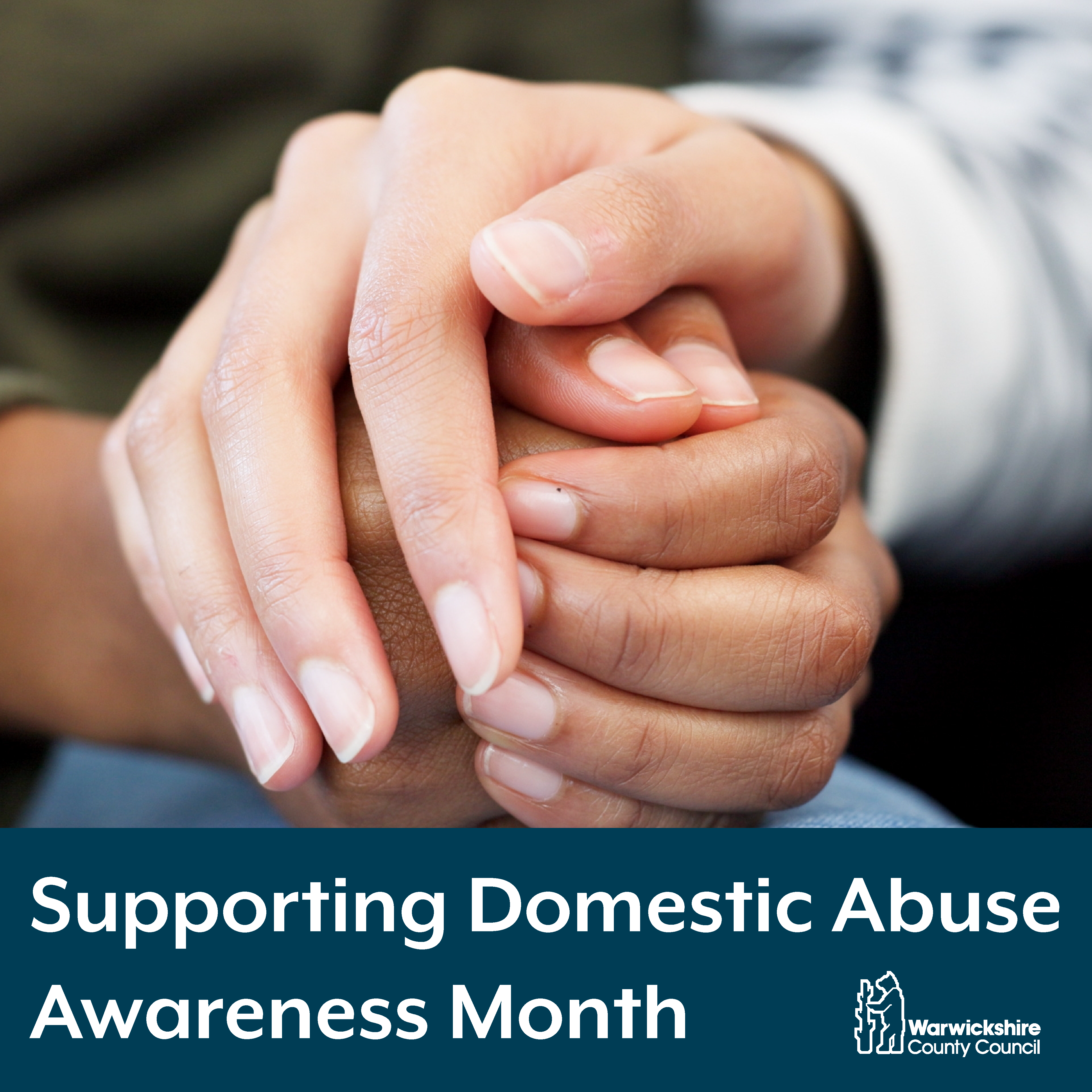Two people holding hands with the text: Supporting Domestic Abuse Awareness Month