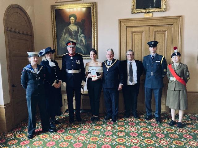 Elizabeth Baitson (fourth from left) being presented with her British Empire Medal by Lord Lieutenant Tim Cox, alongside local dignitaries including the High Sheriff of Warwickshire, Chairman of the County Council, Councillor Chris Kettle, and the Lord Lieutenant’s cadets.