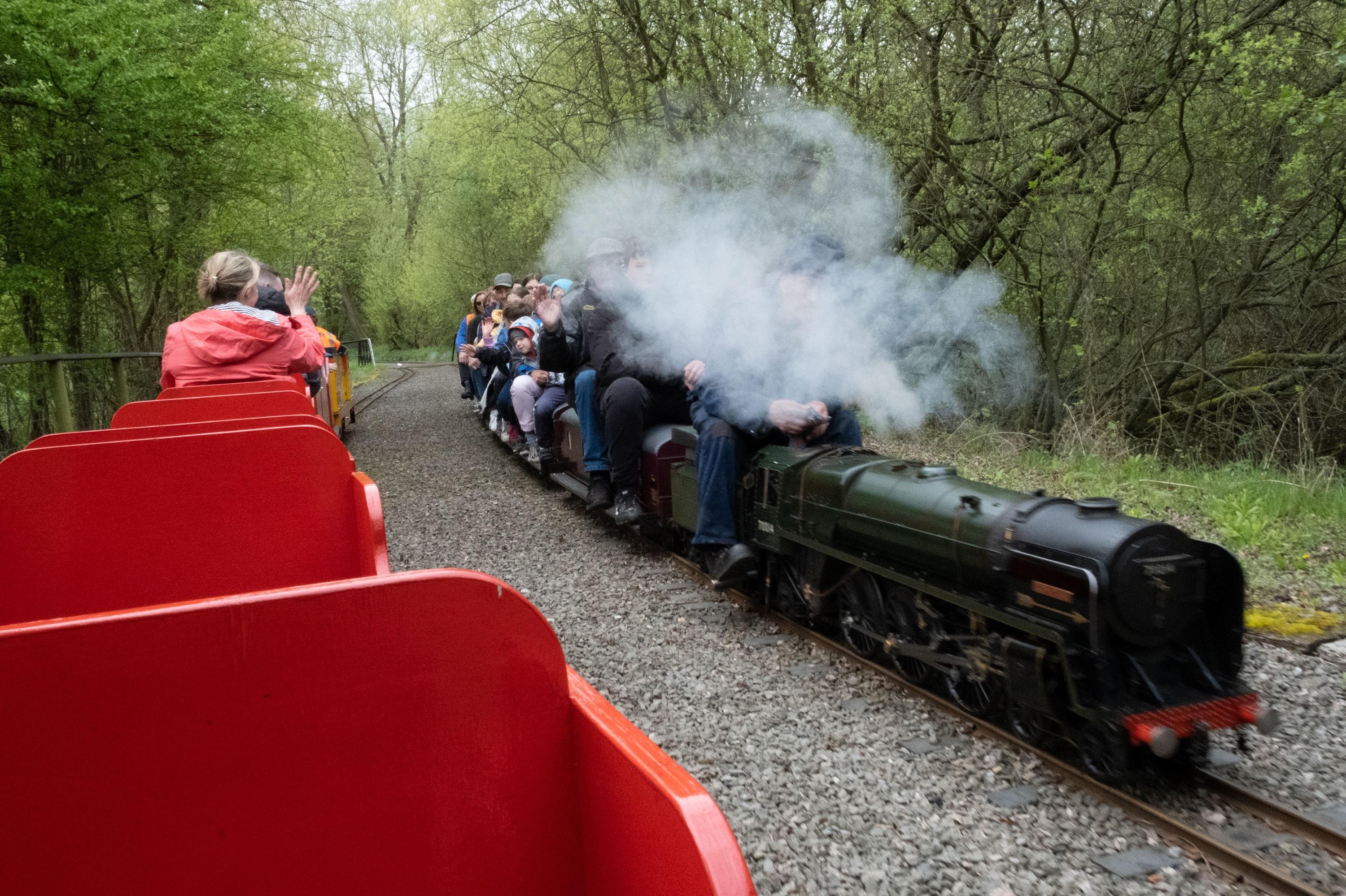 Photograph of a train running at the Echills Wood Railway, with steam rising from the train