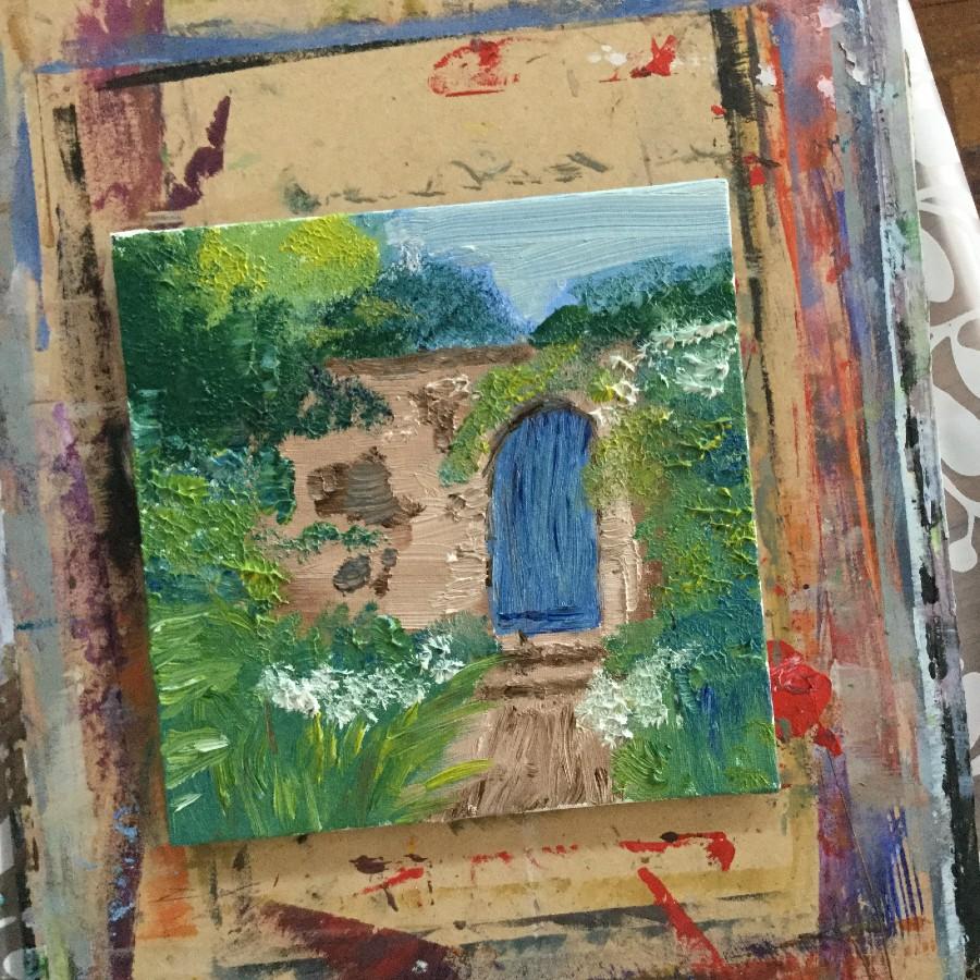 painting of a brown stone wall with stairs leading up to a blue door on the stone wall. Surrounded by greenery.