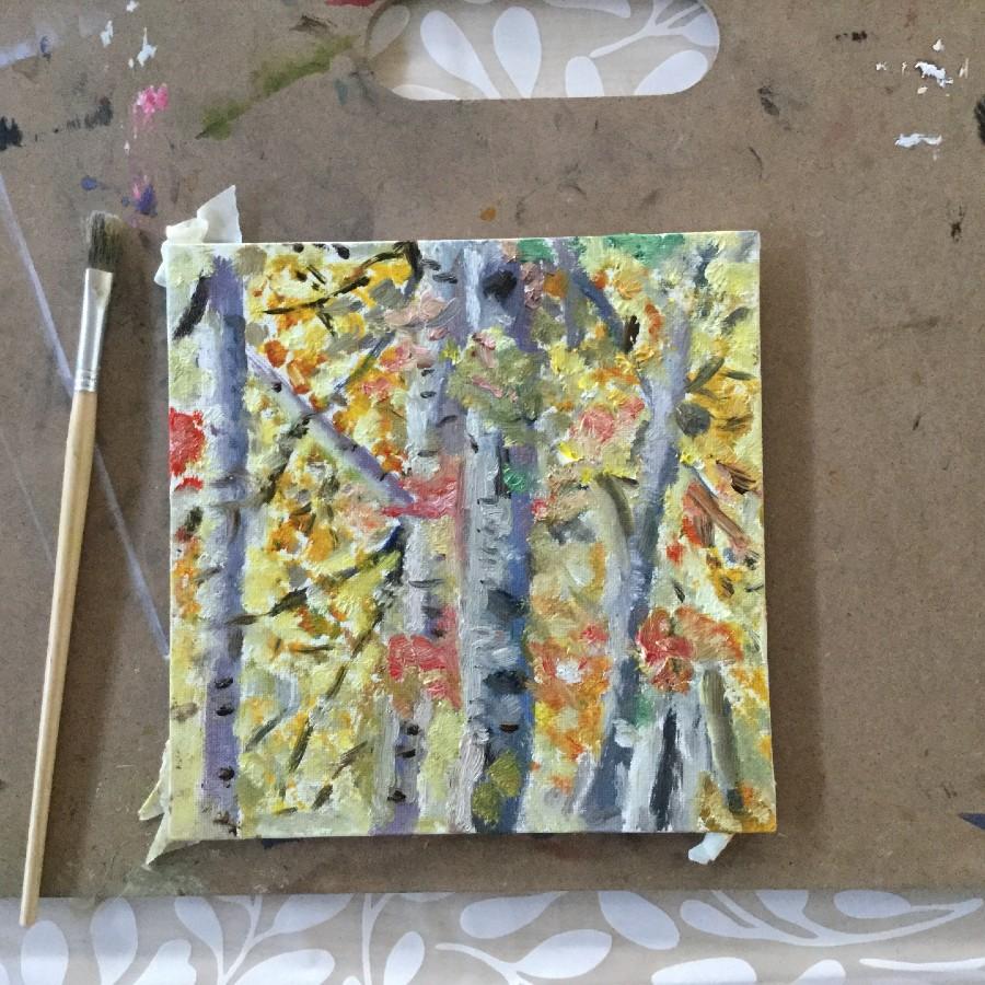 painting of grey thin tree trunks with red, orange and yellow leaves on the tree branches and trunks.