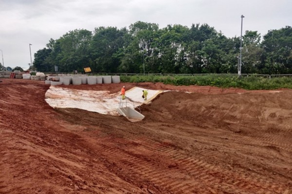 Figure 6 - Geotextile being installed in retention pond