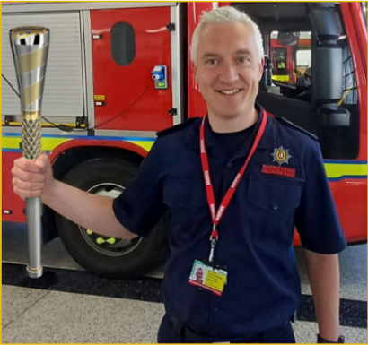 Chief Fire Officer Ben Brook holding virtual Baton of Hope