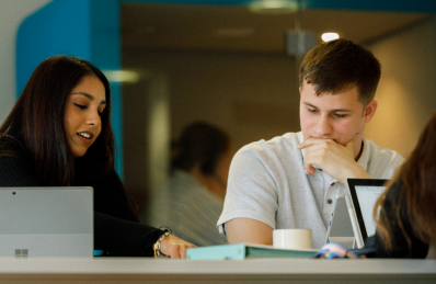 Picture of George and Rajpreet working together at Warwickshire County Council