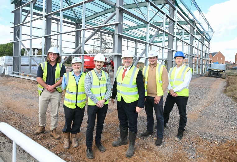 Group of people standing in front of steelwork