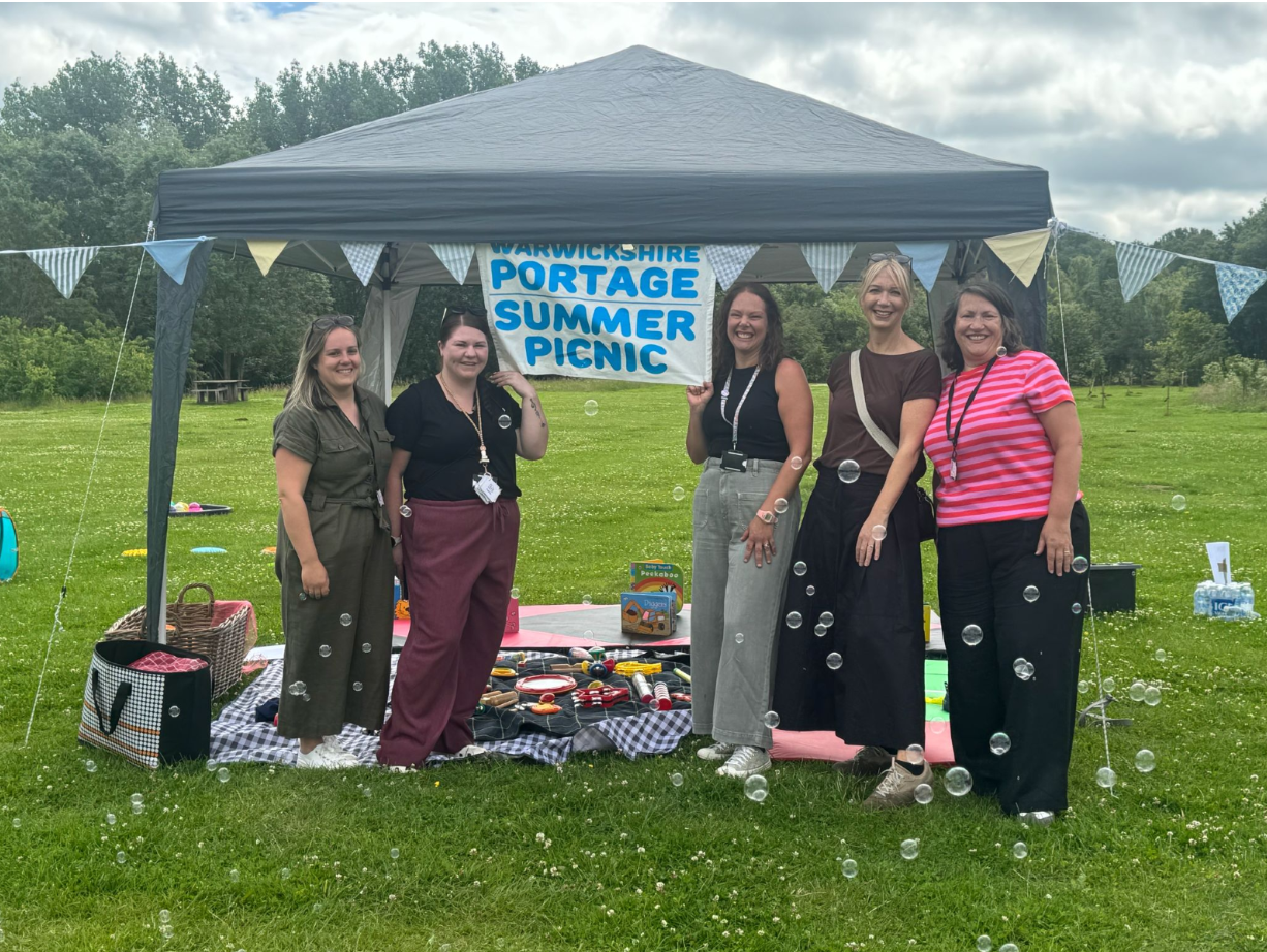 Members of the Early Years Inclusion and SEND team pictured at Ryton Pools in front of a gazebo for the IDS Portage Summer Picnic