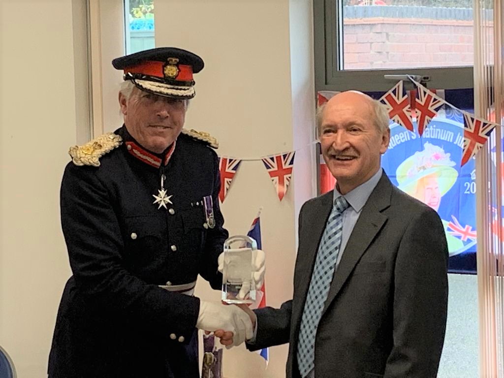 Tony Britton of The Pam Britton Trust for Dementia receives his Queen’s Award for Voluntary Service from Tim Cox, His Majesty’s Lord Lieutenant of Warwickshire.