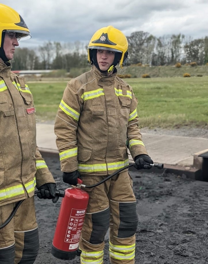 Two firefighters dressed in protective clothing at a training session