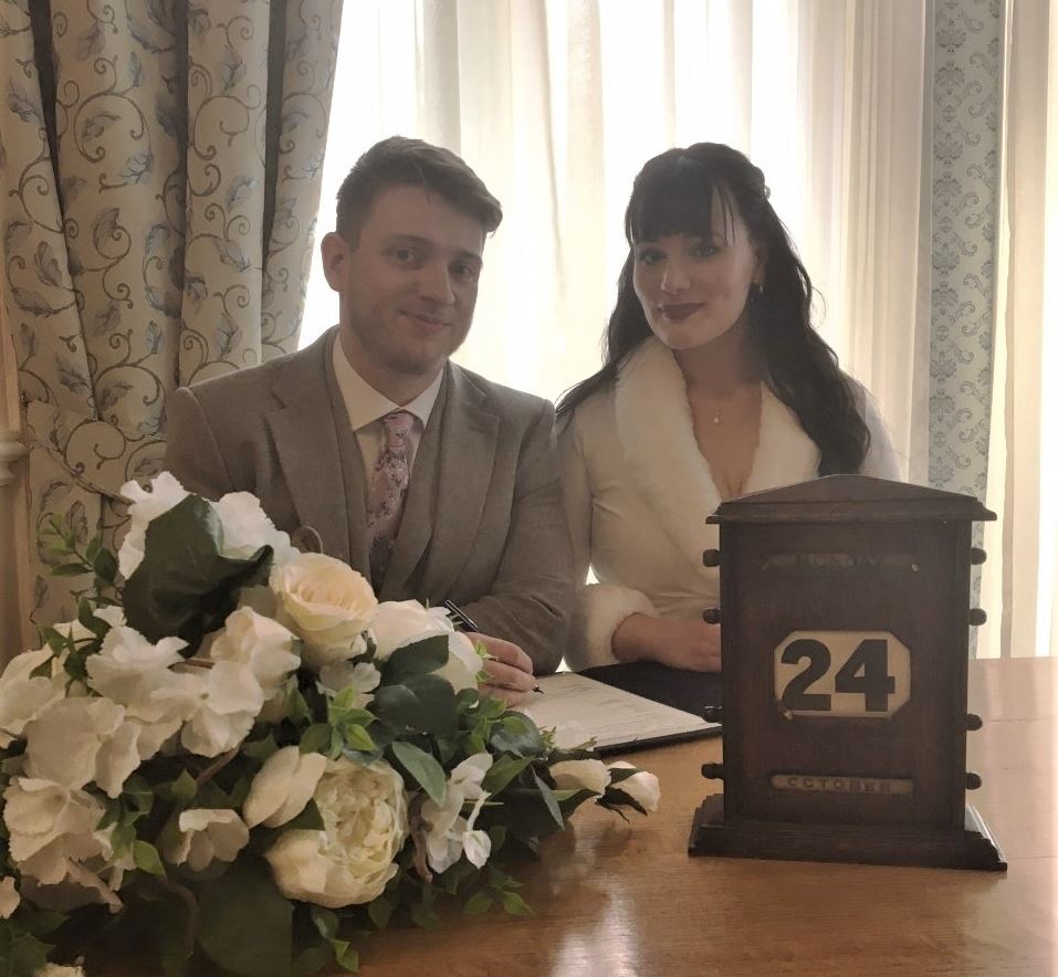 Newlywed couple Georgina and Richard McDonald with the 1930s calendar at Pageant House.