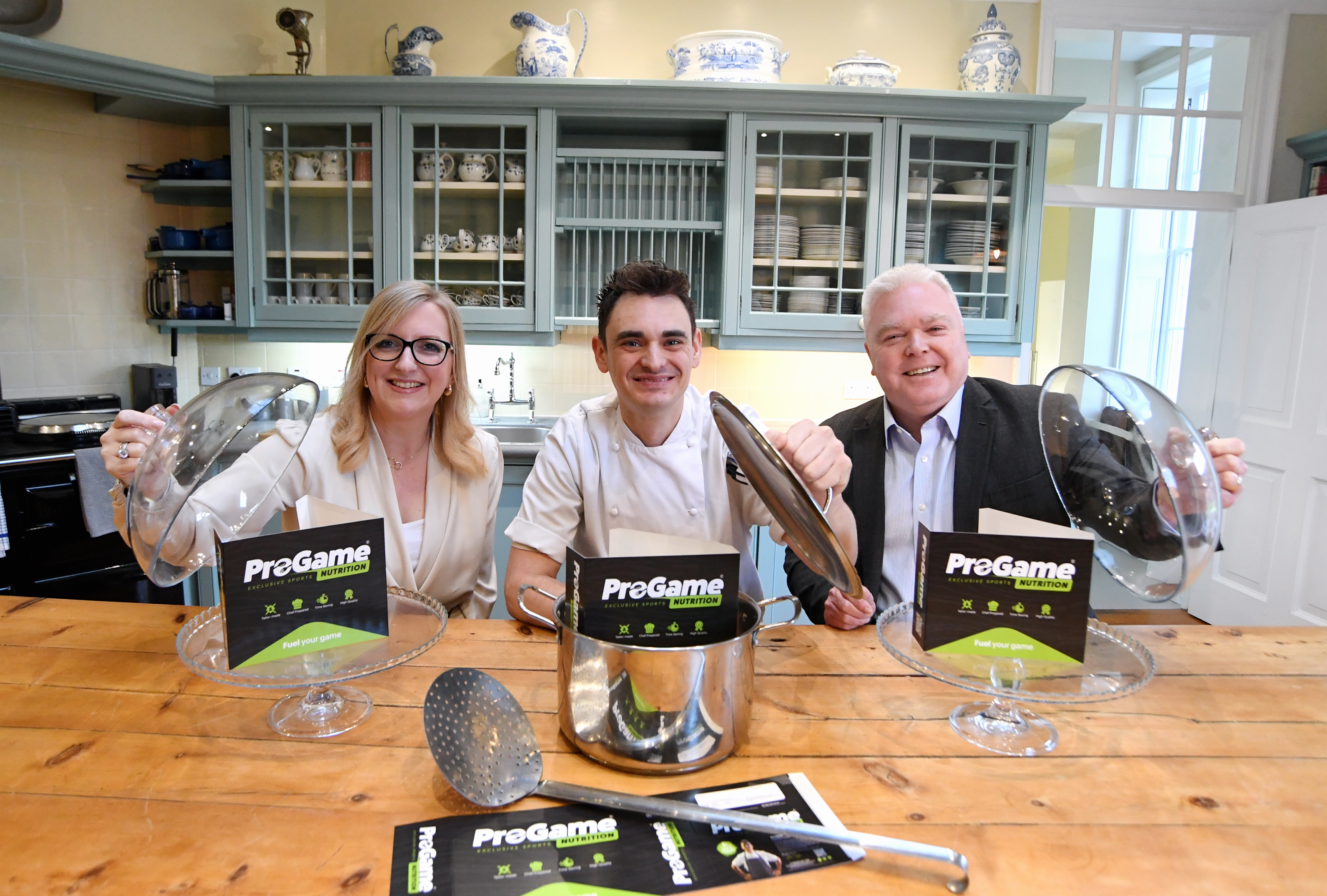 The team at ProGame posing with kitchenware. Councillor Martin Watson is also present.
