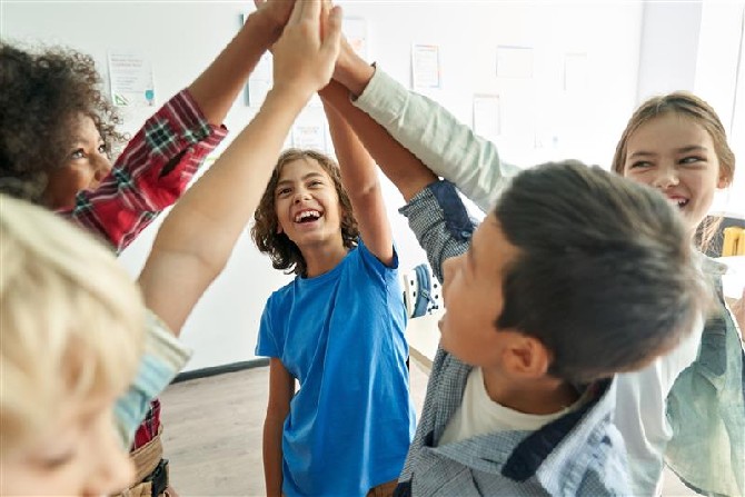 Children giving each other high fives