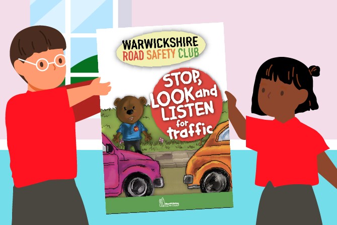 Two children holding up a Warwickshire Road Safety Club leaflet