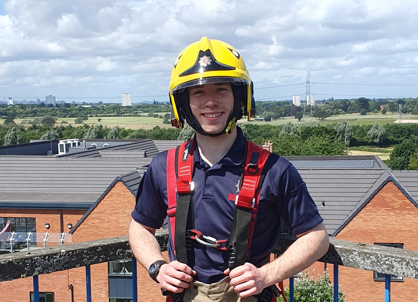 Smiling firefighter in uniform standing on balcony