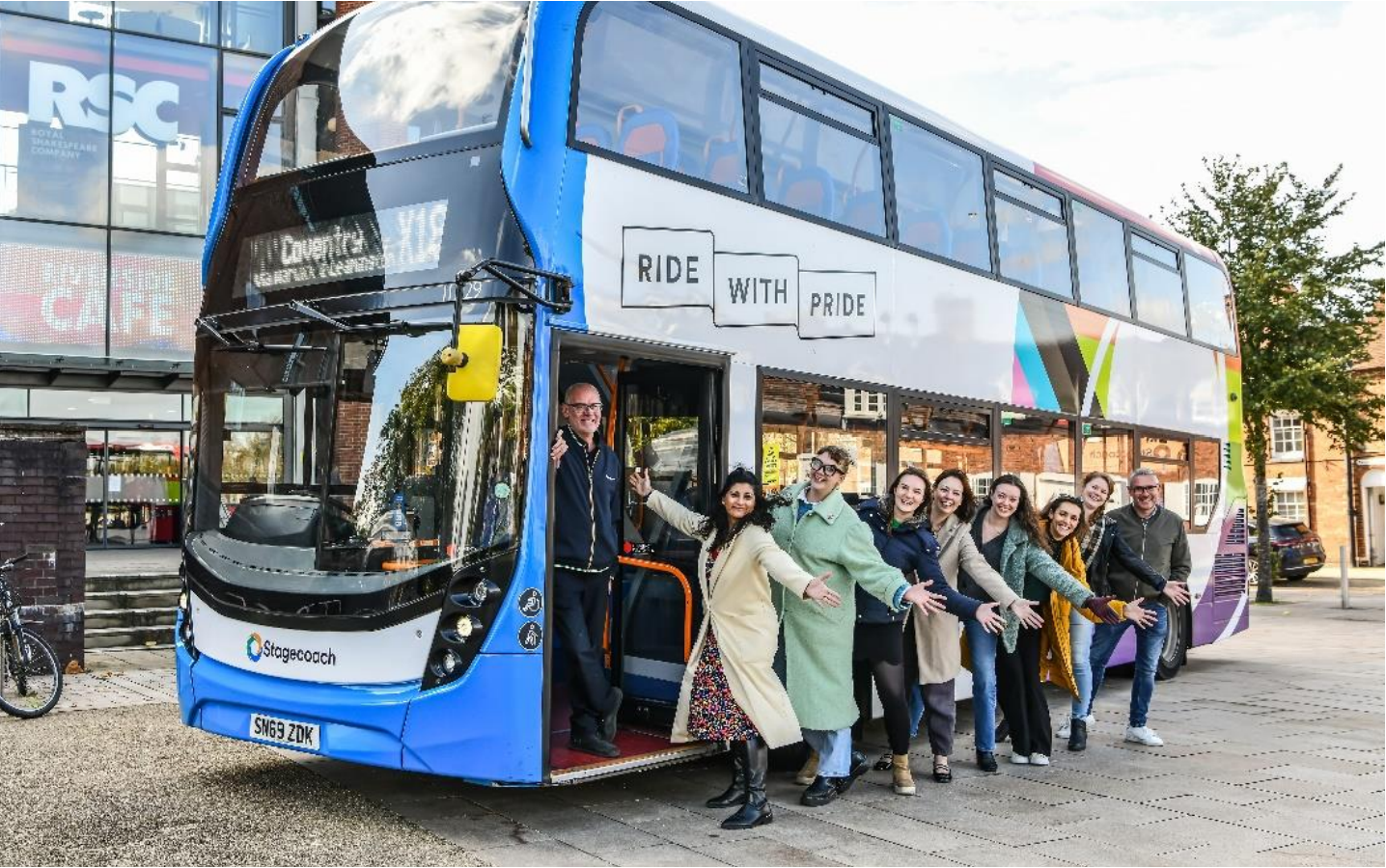 People on a bus next to the RSC.