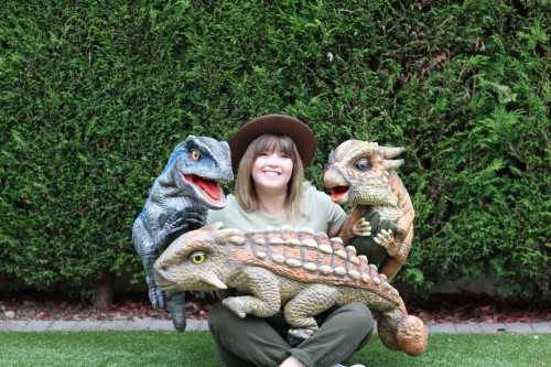 A person holding toy dinosaurs