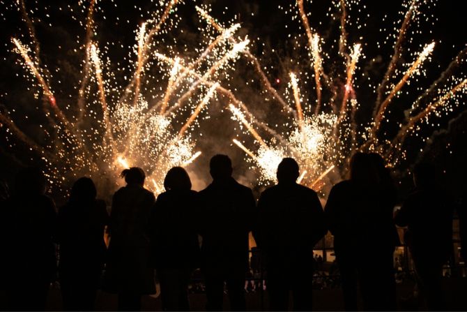 A crowd of people watching a fireworks display