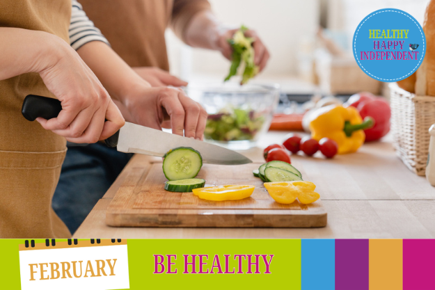 Someone slicing a cucumber for a salad