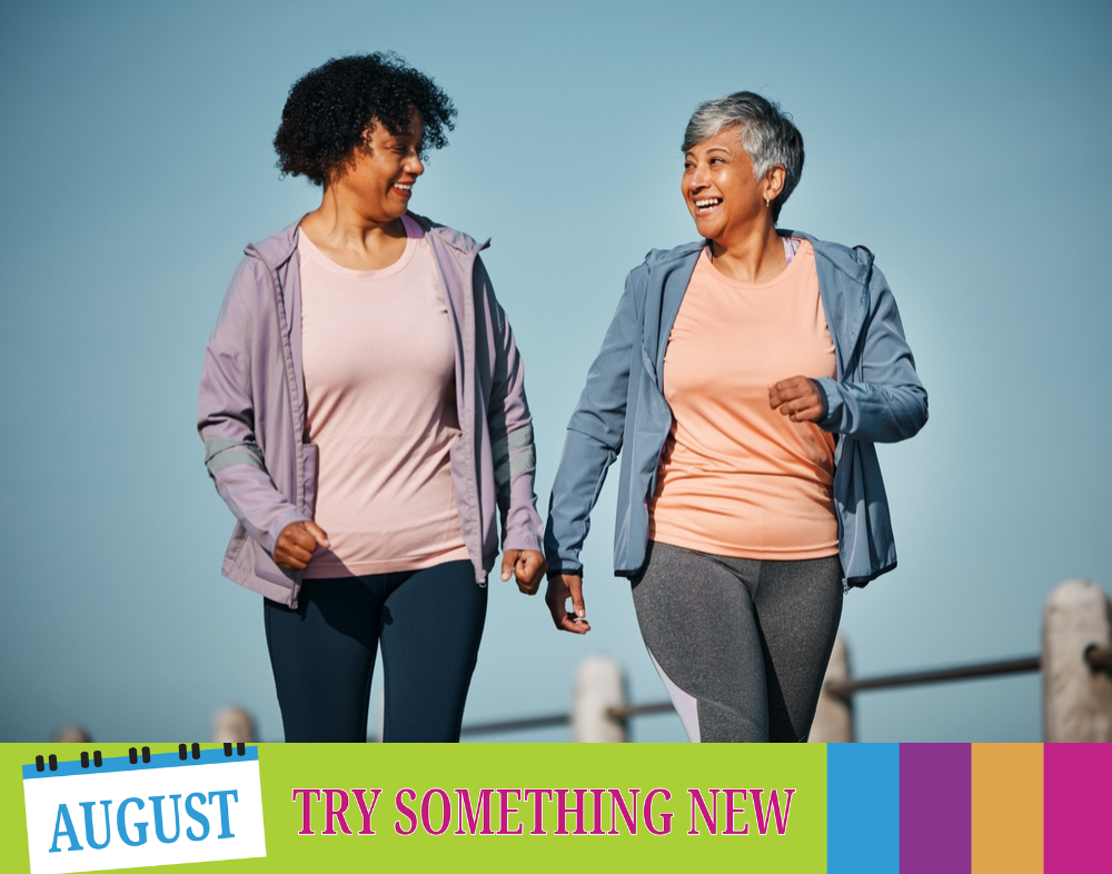 Two women walking together, smiling
