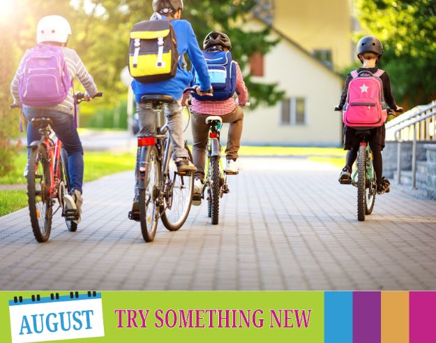 Children cycling to school with backpacks on
