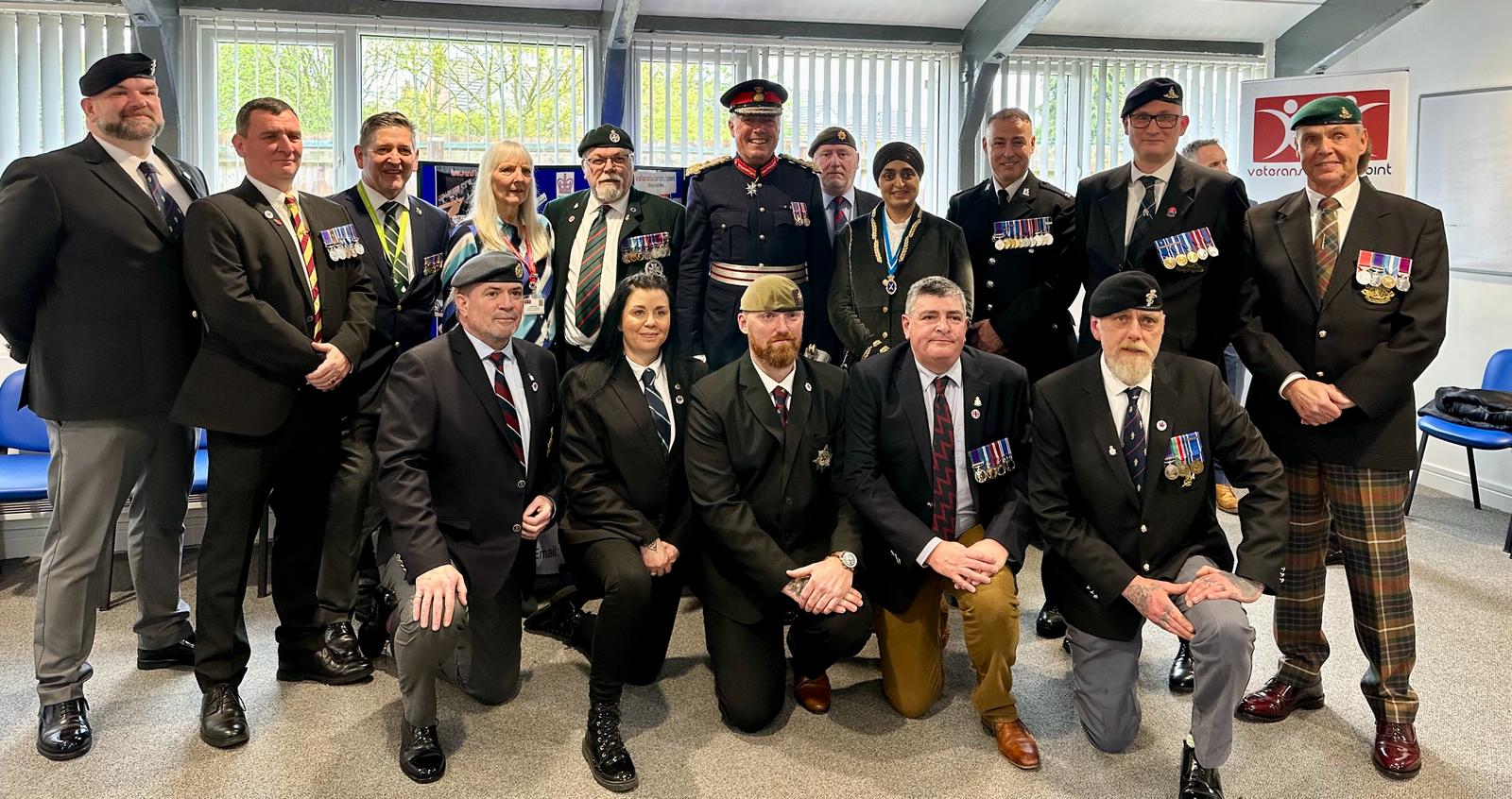 Members of the Veterans Contact Point receive their Kings Award for Voluntary Service from Tim Cox, Lord Lieutenant of Warwickshire accompanied by Rajvinder Kaur Gill, High Sheriff of Warwickshire.