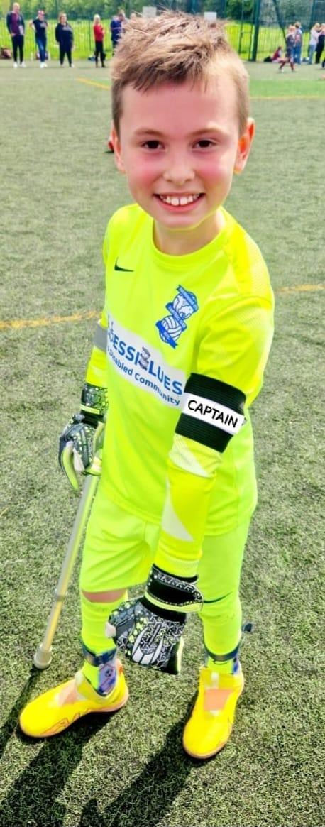 10-year-old Vinnie wearing his Accessiblues football strip