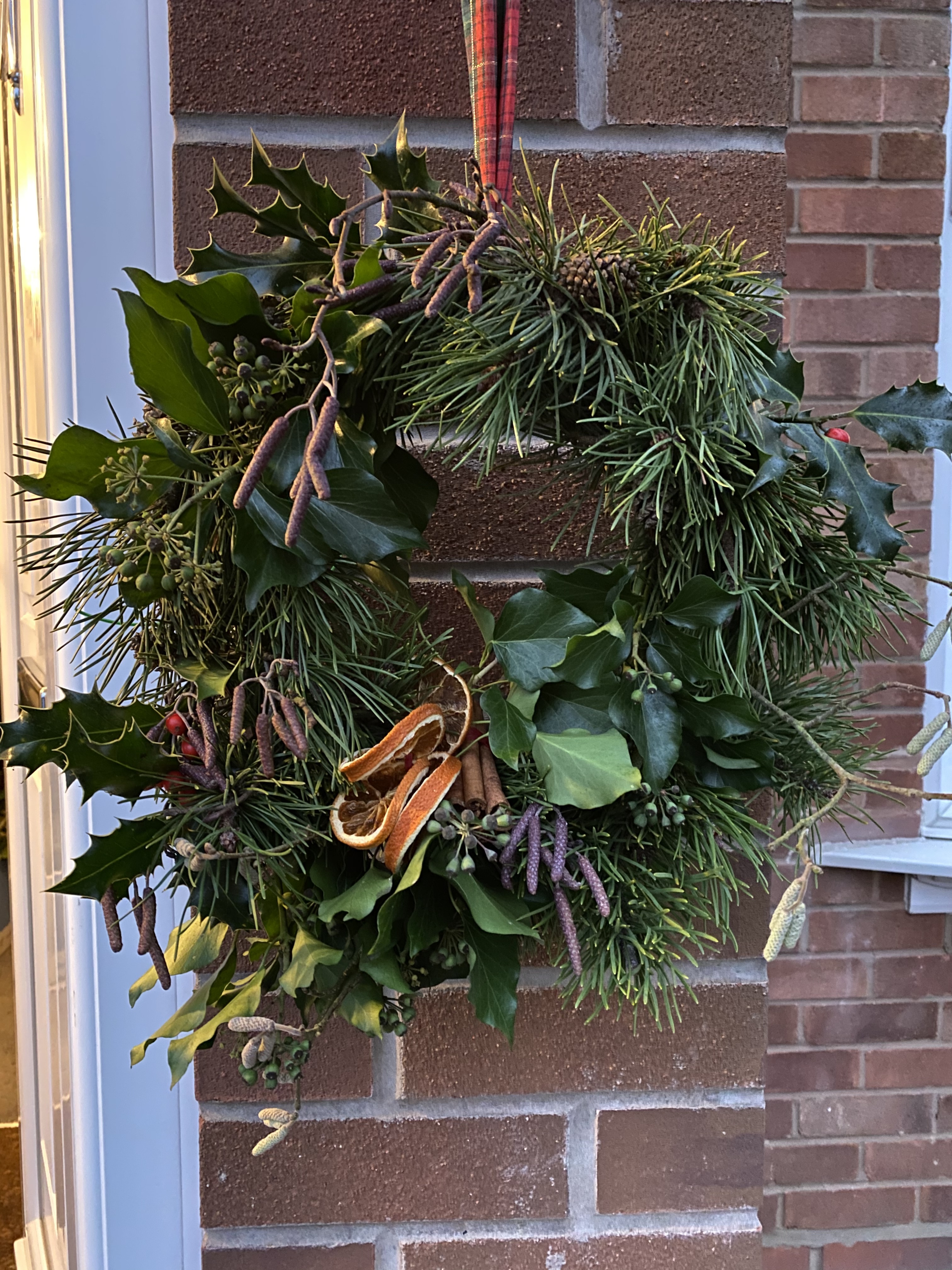 A christmas wreath adorning a front door