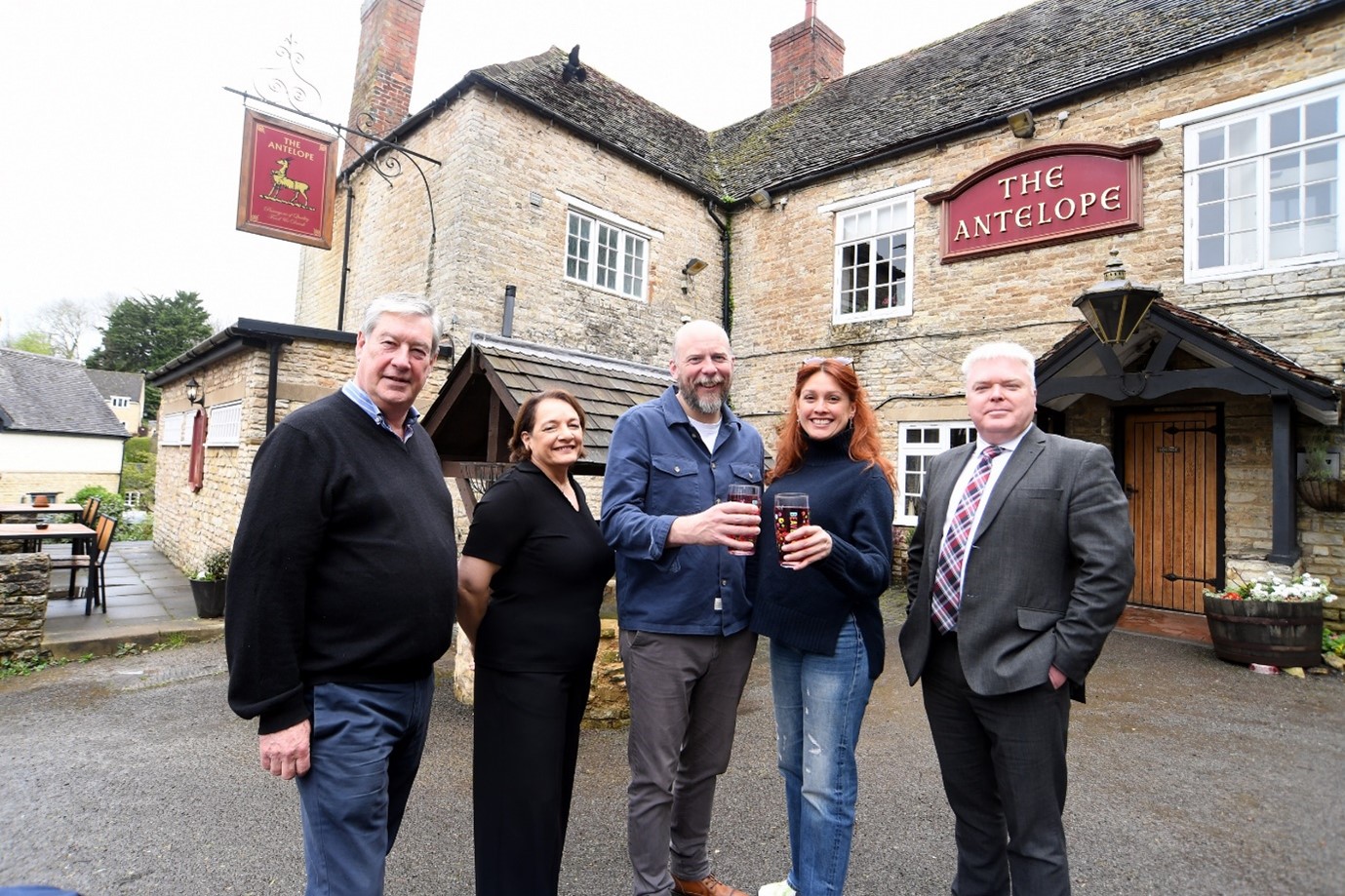 Left to right, the photograph shows Councillor Malcolm Littlewood, Marie Stephenson, Tom Lilley, Erika Lilley, Councillor Martin Watson standing outside the Antelope pub.