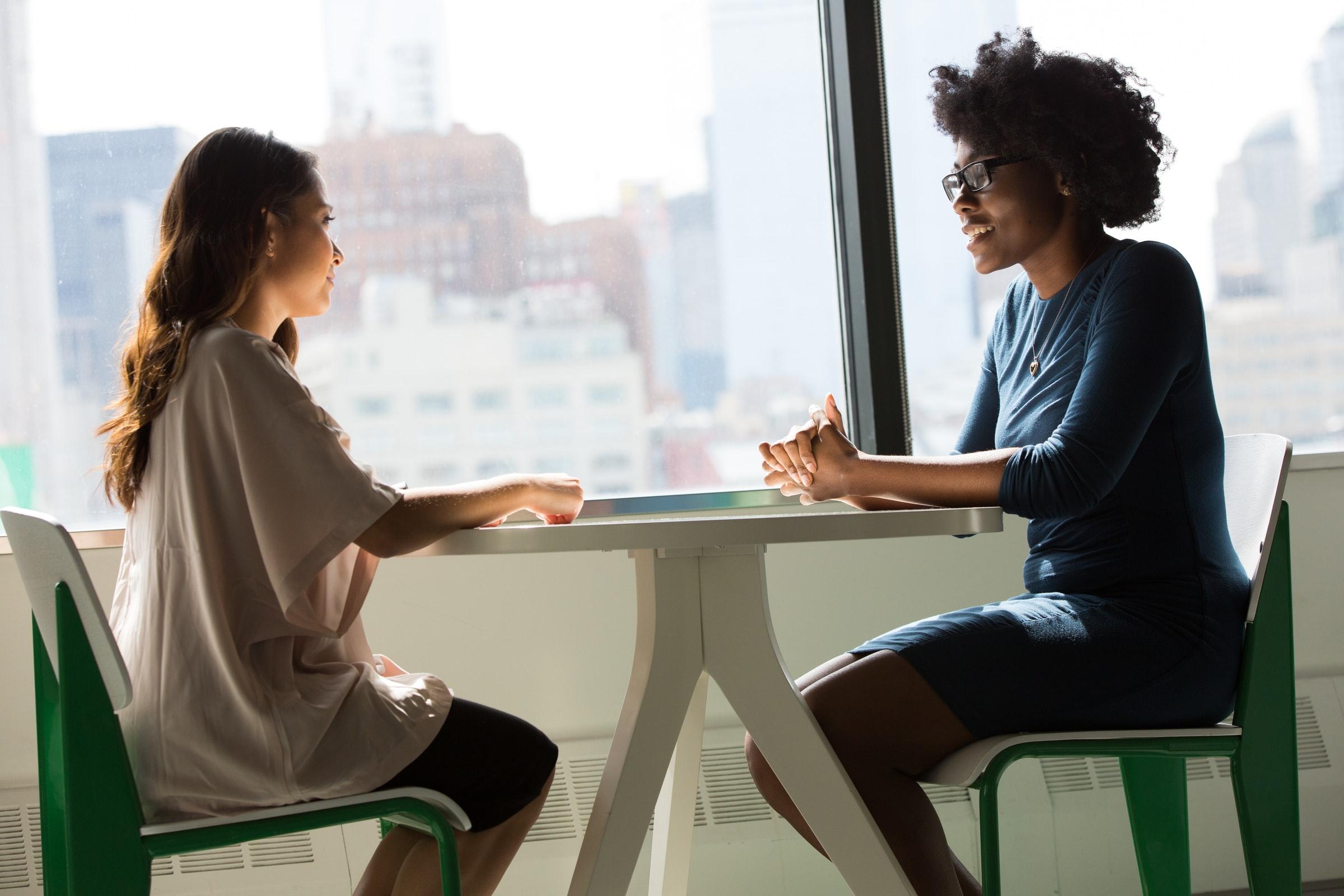 Two people sat at a table talking