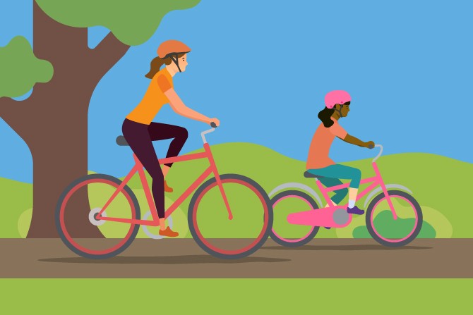 A parent and child cycling through a country park