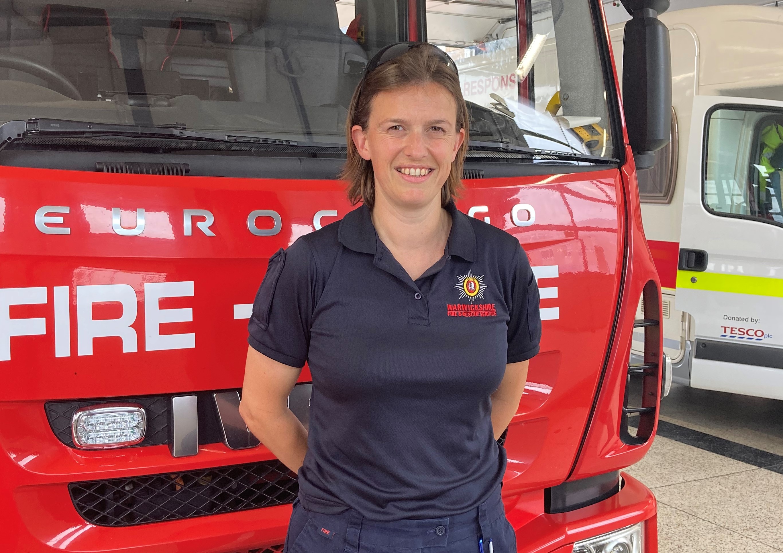 Firefighter Julia Treen in front of fire engine