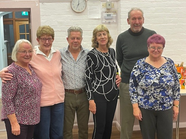 Paul and Heather Dowler (centre left and right), with talkdementia  volunteers celebrating their Kings Award for Voluntary Service at Wellesbourne village hall recently.