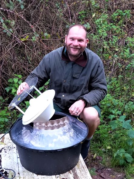 checking the contents of a moth trap before recording and releasing the moths.