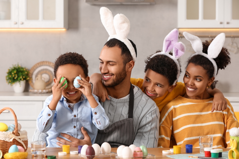 A family decorating easter eggs in a kitchen